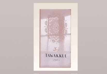 a picture frame with a picture of a mandala on it that says tawakul trust