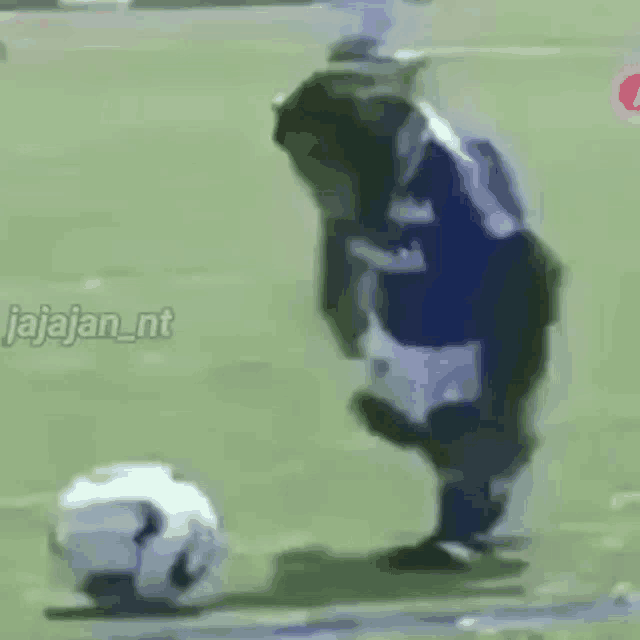 a soccer player is kicking a soccer ball on a field .