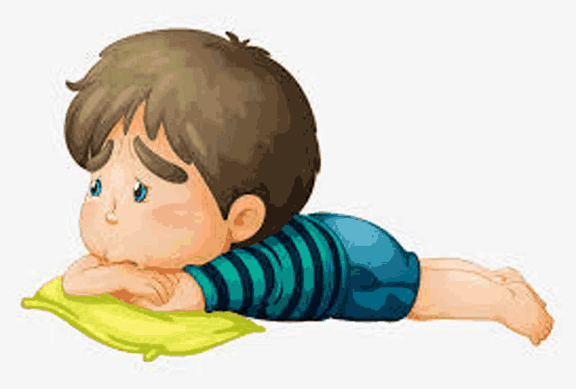 a boy is laying on his stomach on a pillow .