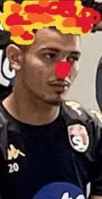 a man wearing a red nose and a black shirt with the number 20 on it .