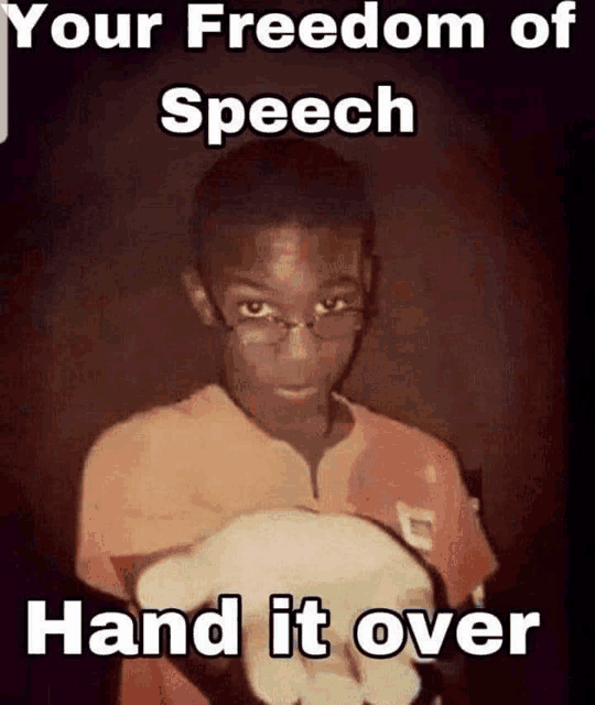 a young boy with glasses is holding a piece of paper with the words " your freedom of speech hand it over "