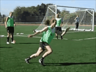 a group of women are playing soccer on a field and one of them is jumping in the air .