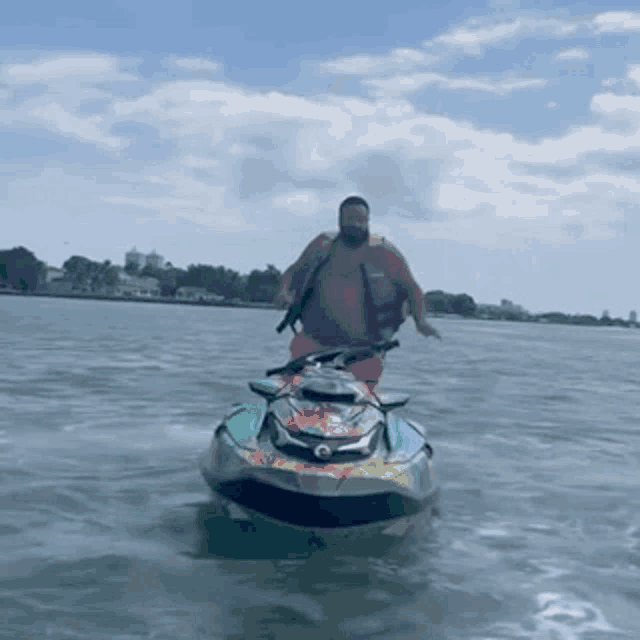 a man is riding a jet ski through the water .