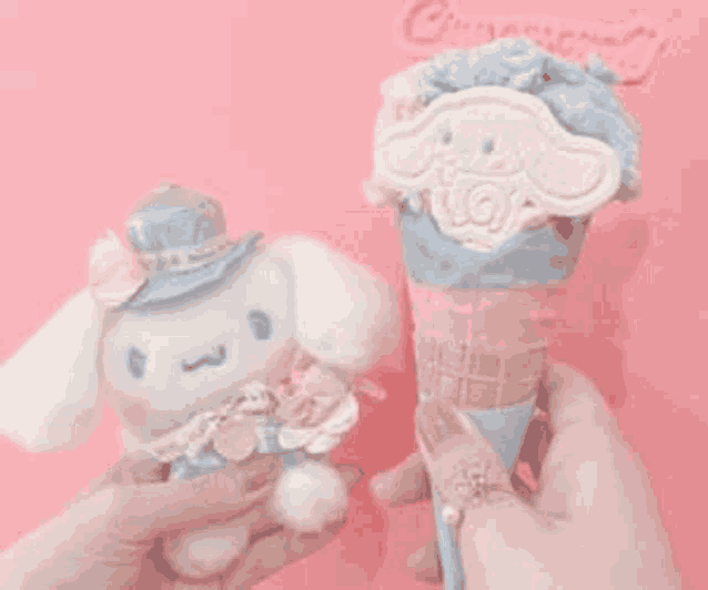 a person is holding a stuffed animal and a ice cream cone with a cinnamoroll on it .