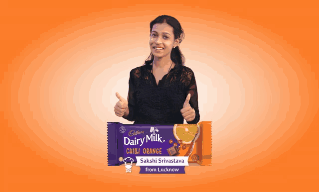 a woman is giving a thumbs up next to a bar of dairy milk chocolate