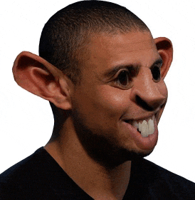 a man with big ears is smiling and looking at the camera