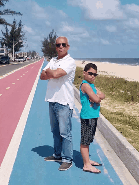 a man and a boy standing next to each other on a sidewalk