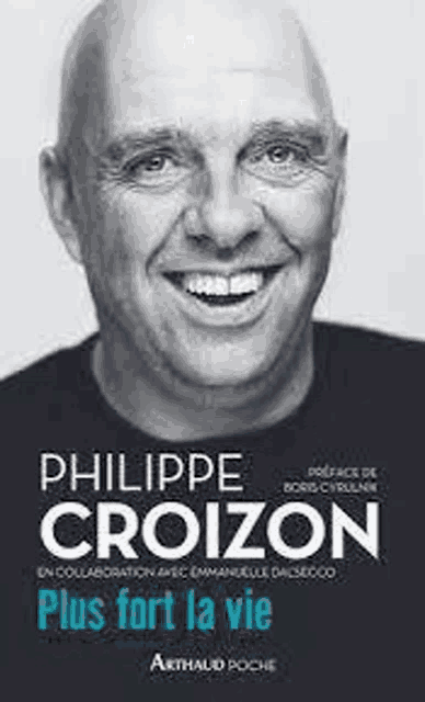 a black and white photo of a bald man smiling on a book cover .