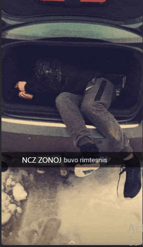 a man is laying in the back of a car with ncz zonoj written on the bottom