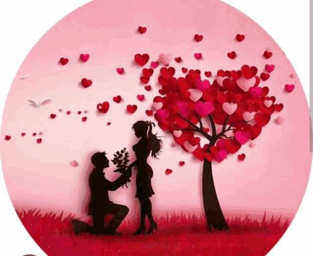 a man is kneeling down and giving a bouquet of flowers to a woman under a tree with hearts on it .