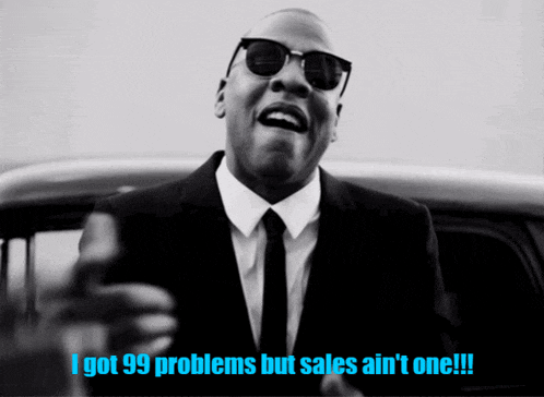 a man in a suit and tie says i got 99 problems but sales ain 't one !!