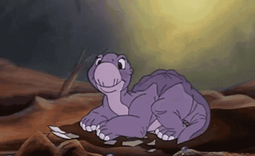 a cartoon purple dinosaur is laying on the ground and smiling .