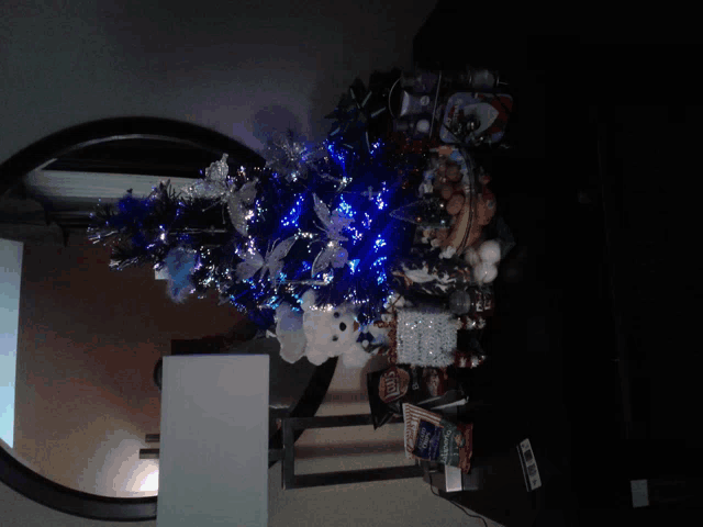 a christmas tree with blue lights is on a table