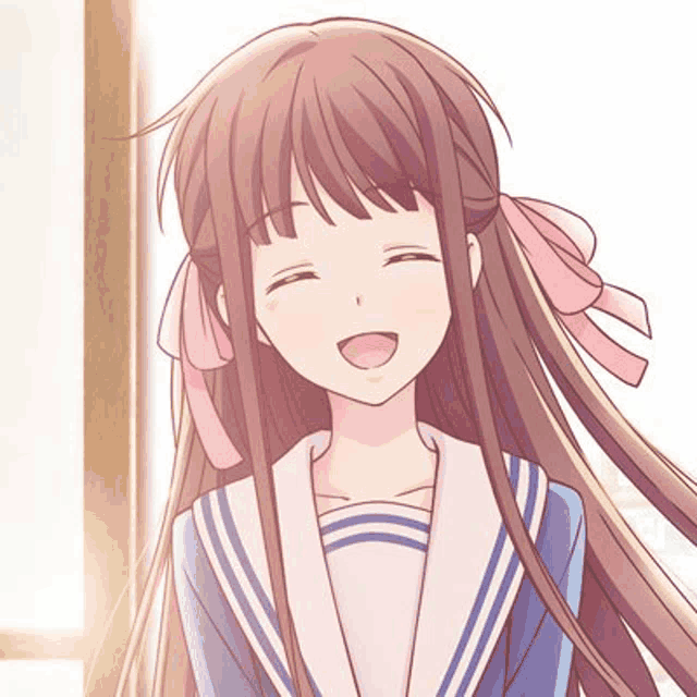 a girl with long brown hair and a pink bow in her hair is smiling and wearing a school uniform .