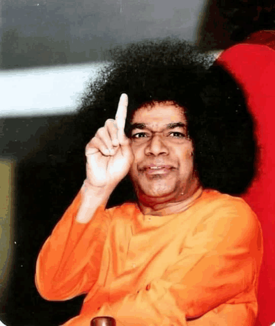 a man with a big afro is making a gesture with his finger