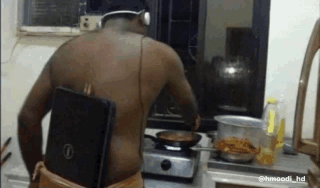 a man with a dell laptop on his back is cooking