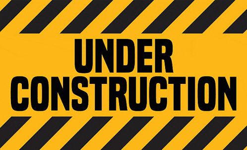 a yellow sign that says under construction with black stripes