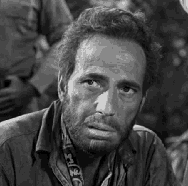 a black and white photo of a man with a beard and a scarf around his neck that says ' jeep '