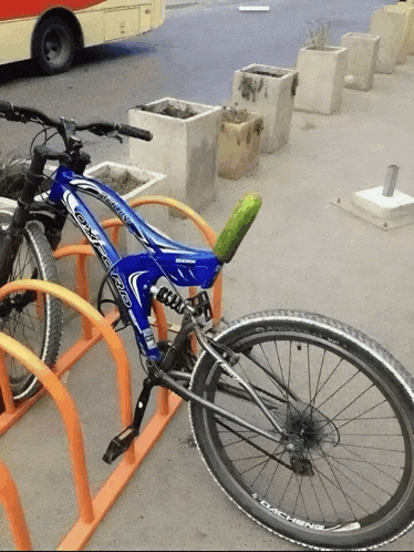 a blue o'neill bicycle is parked in a rack