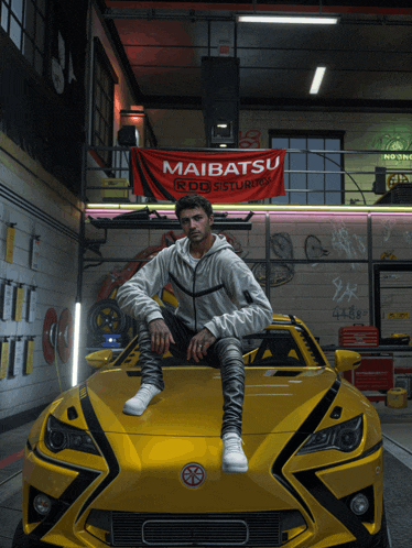 a man sits on the hood of a yellow car in a garage