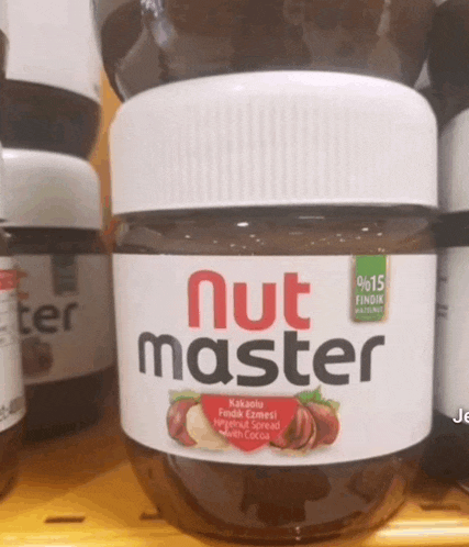 a jar of nut master is on a yellow shelf