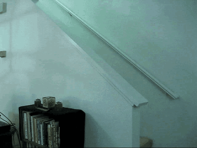 a staircase with a shelf full of books including one titled ' a brief history of the united states '