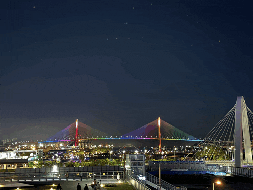 a bridge with a rainbow of lights on it