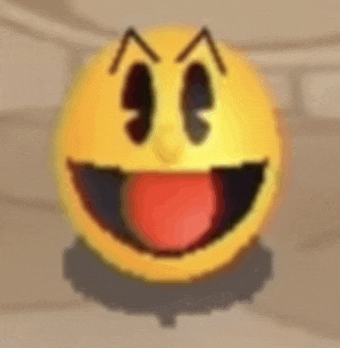 a yellow smiley face with a red tongue sticking out is sitting on a table .