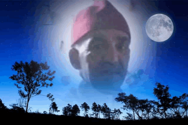 a man 's face is projected on a blue sky with trees in the foreground and a full moon in the background