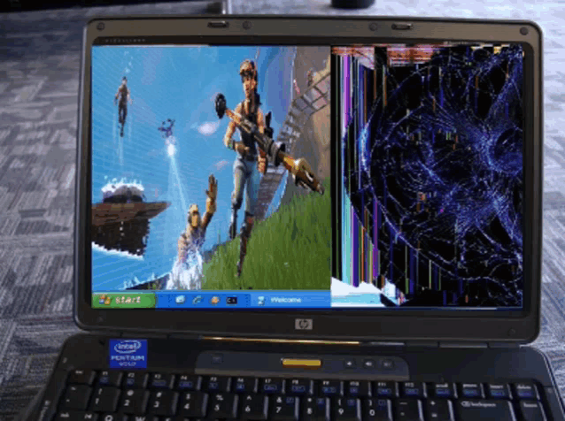 a hp laptop with a broken screen shows a video game on the screen