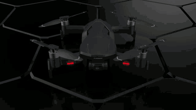 a futuristic looking drone is sitting on top of a dark surface