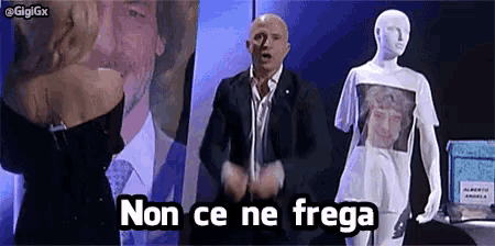 a man in a suit is standing in front of a mannequin with a shirt that says non ce ne frega .