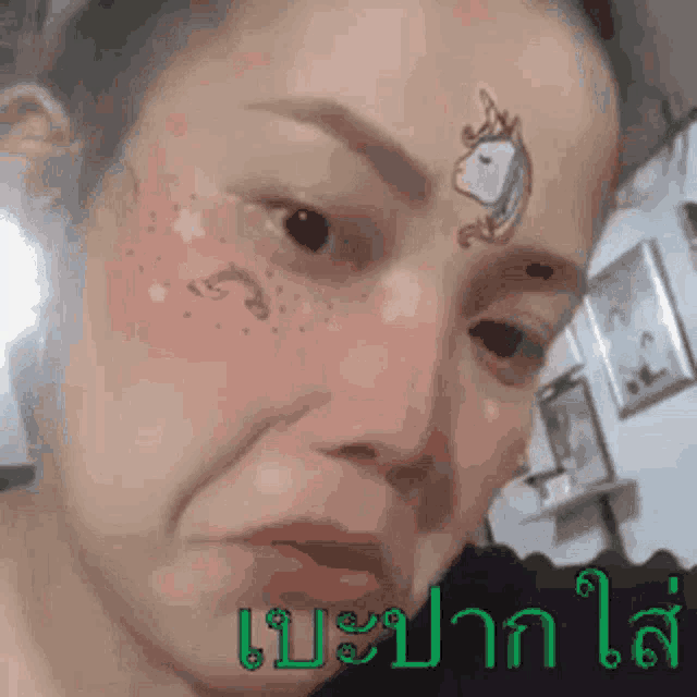 a woman with a tattoo of a unicorn on her forehead