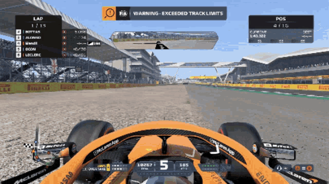 a mclaren race car is driving down a track with a warning sign above it