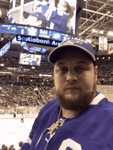 a man wearing a jersey with the number 2 on it stands in front of a sign that says scotiabank arena