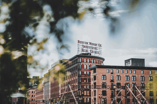 a boston wharf co industrial real estate sign is above a brick building