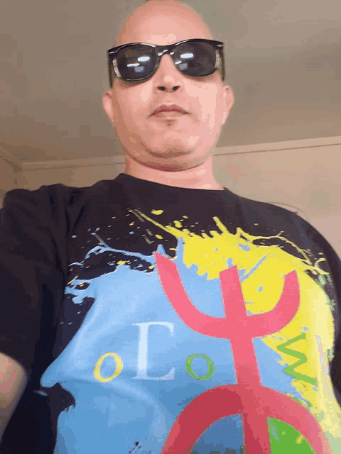 a man wearing sunglasses and a t-shirt that says olo