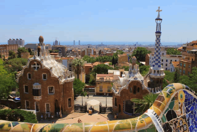 a view of a city with a tower in the foreground and a building in the background