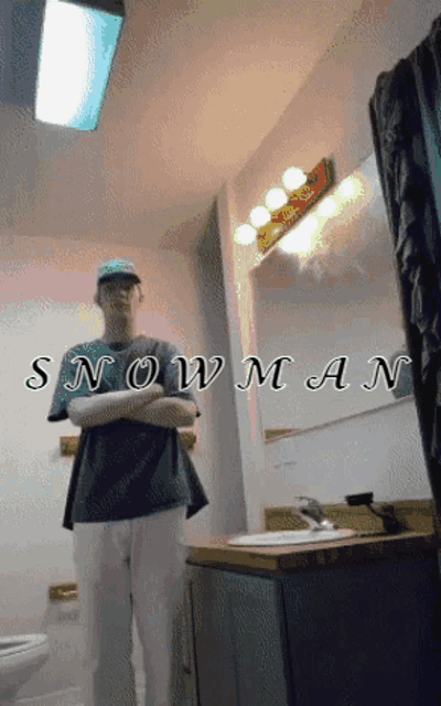 a man standing in a bathroom with the word snowman on the bottom right