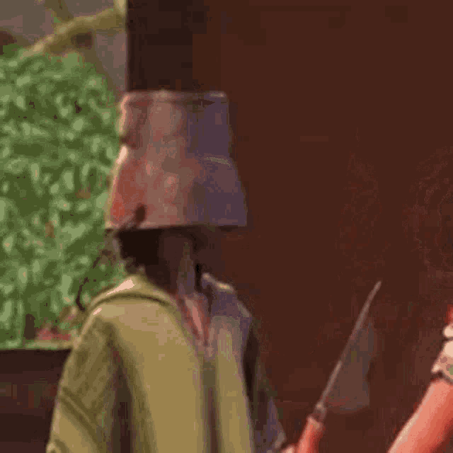 a man with a bucket on his head is holding a knife next to a woman holding a knife .