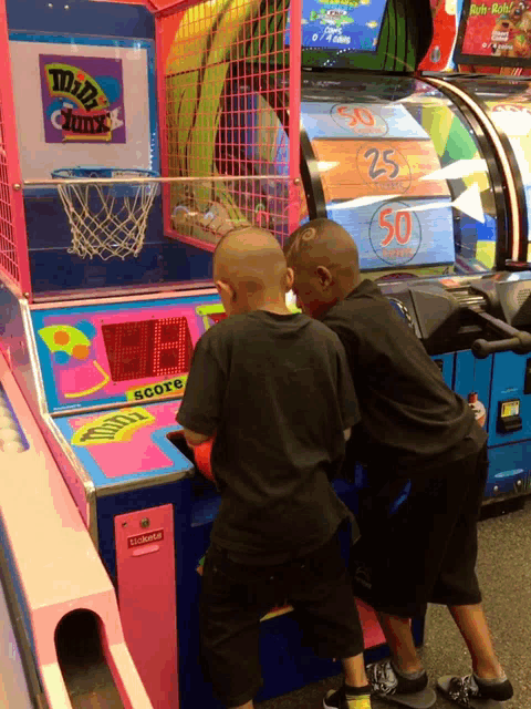 two boys are playing a basketball game with a score of 28 to 50