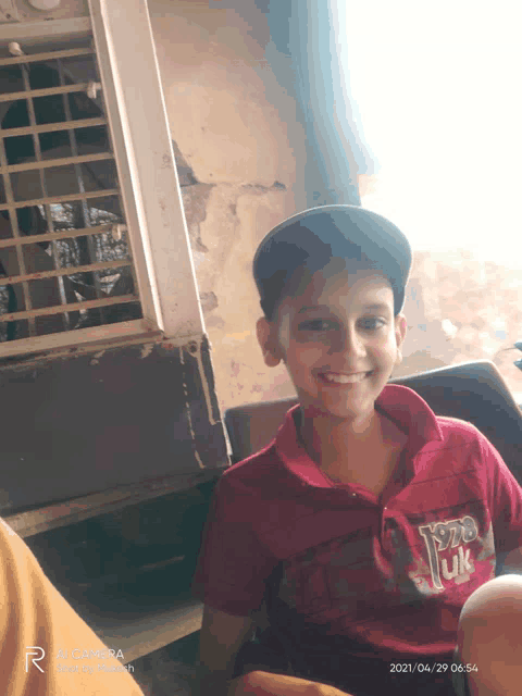 a young boy wearing a red shirt that says york