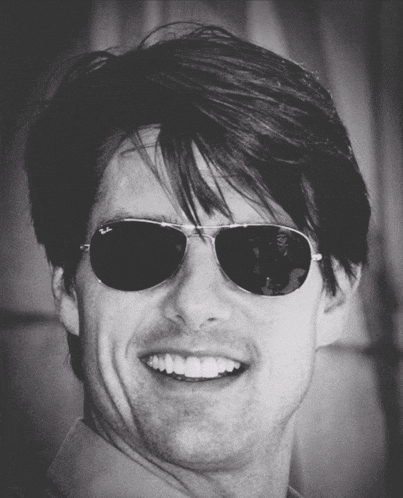 a black and white photo of a man wearing ray ban sunglasses