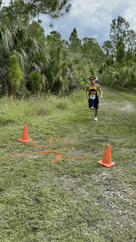 a person wearing a yellow shirt that says ' florida ' on it is running on a trail