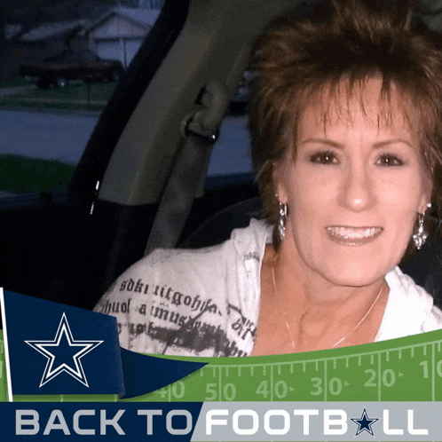 a woman in a car with a back to football sign