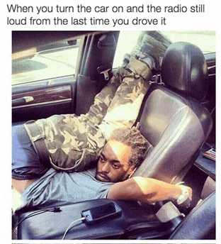 a man laying in the back seat of a car