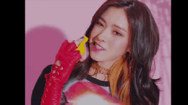 a woman wearing red gloves and a yellow object in her mouth