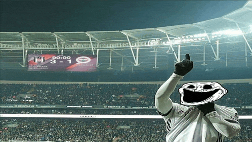 a soccer player giving a thumbs up in front of a scoreboard that says 3 1