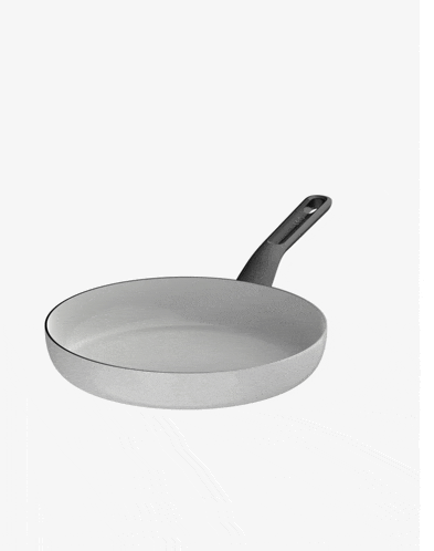 a white frying pan with a black handle on a white surface