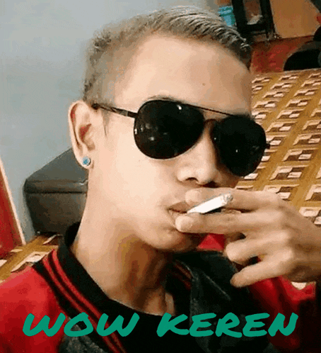 a man wearing sunglasses is smoking a cigarette and the words wow keren are behind him